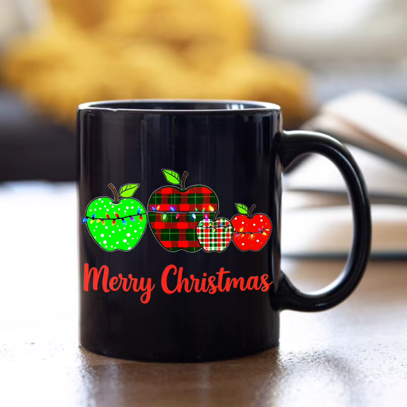 Tasse à café noire avec motif pomme de Noël et texte "Joyeux Noël"